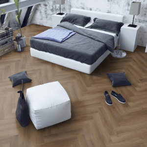 SPC-HER-TO Truffle Oak Herringbone flooring in a bedroom